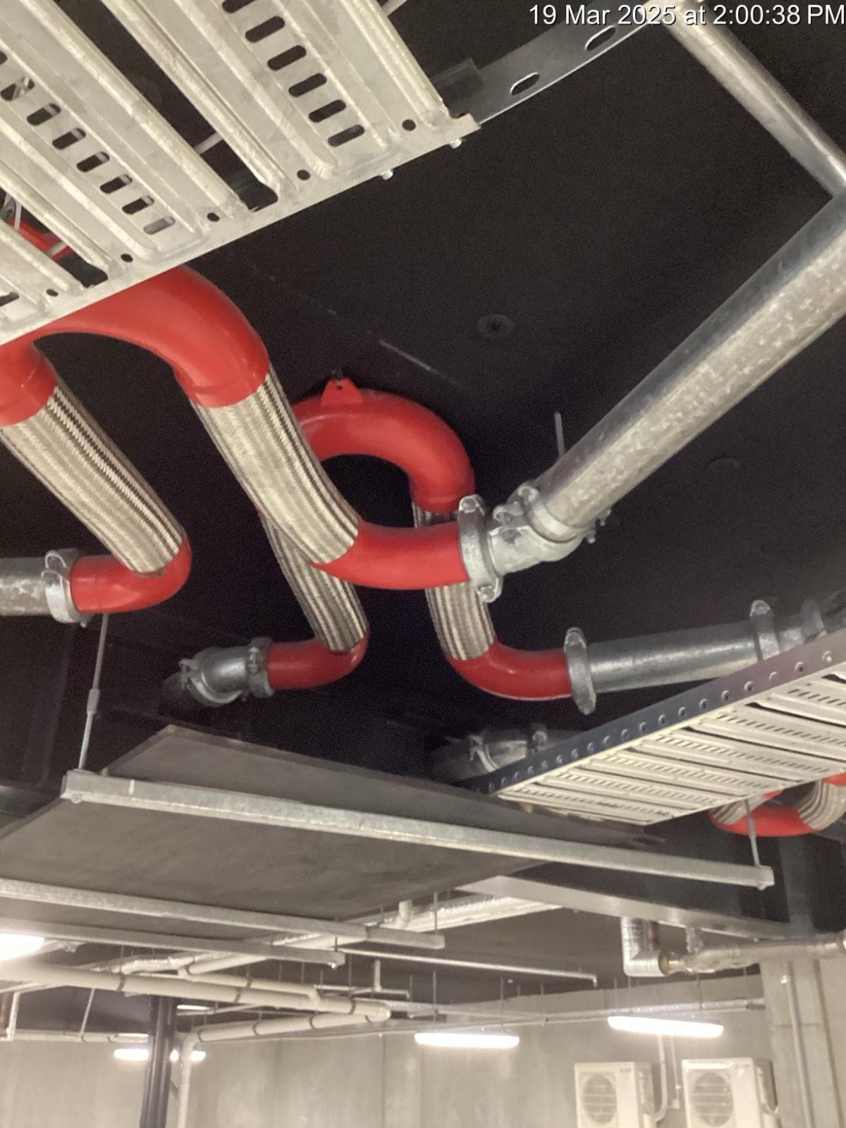 Soffit liner panels installed to a residential carpark ceiling, cut cleanly around pipework and cable tray