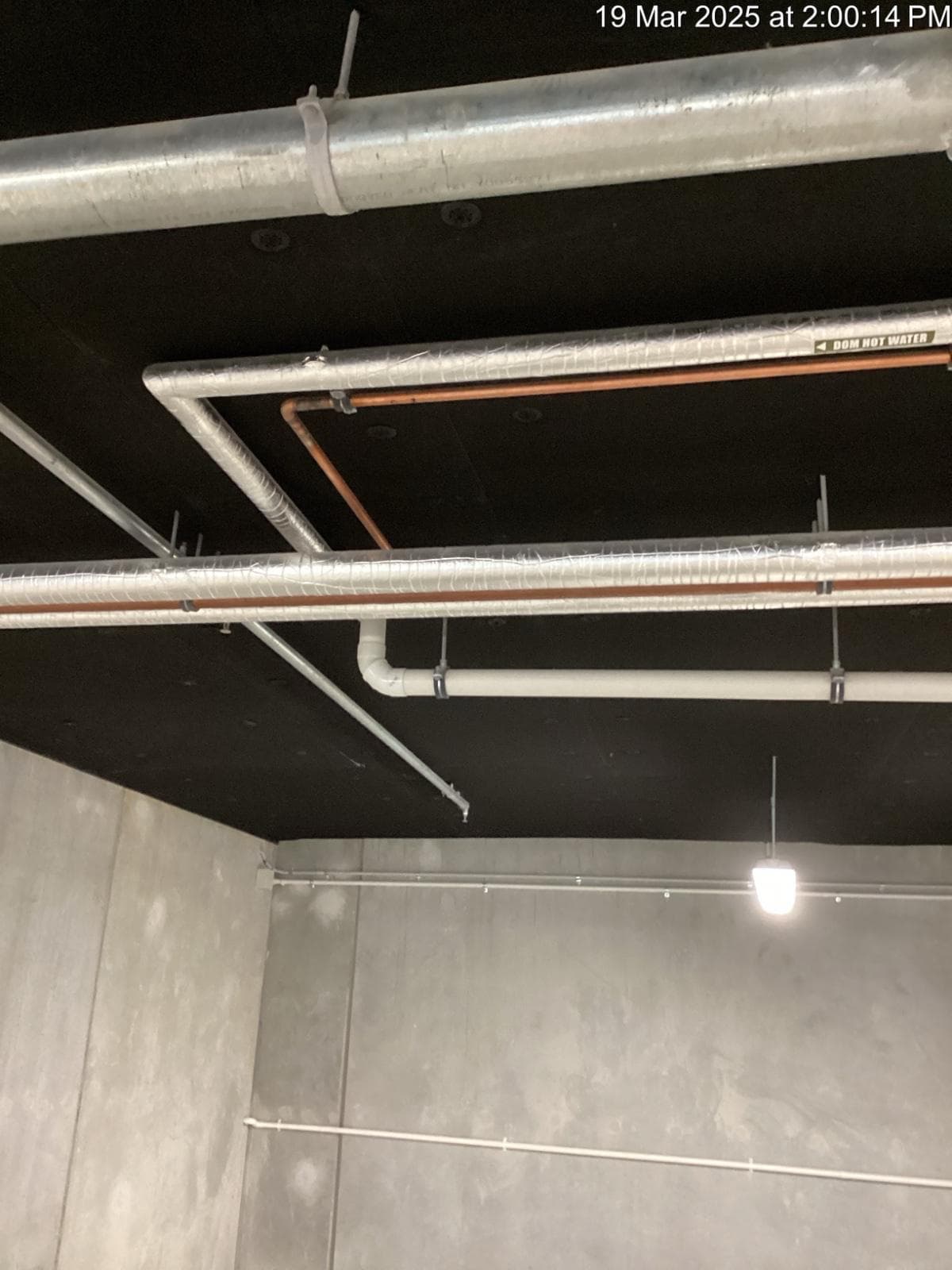 Carpark soffit with insulation panels installed between services and light fittings